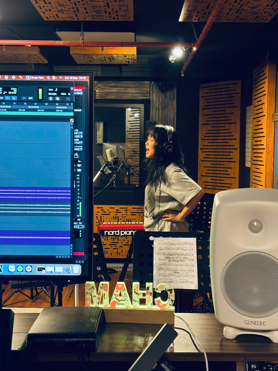 Following the lead vocal from the control room.